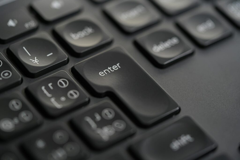 Detailed close-up photograph of a black keyboard's enter key, showing precision and modern design.